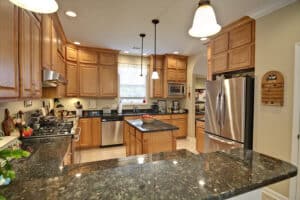 spacious modern kitchen with maple cabinets and granite